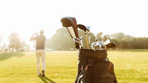 back-view-male-golfer-swinging-golf-club-scaled